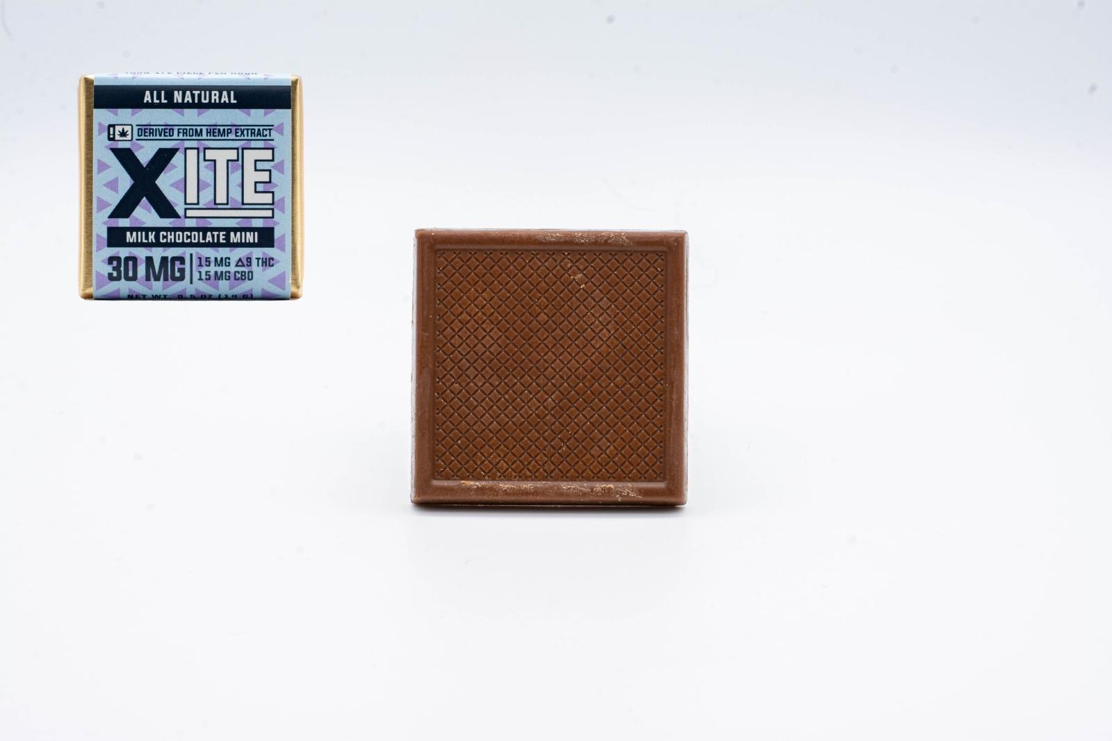 One unwrapped Xite 1:1 Delta 9 Milk Chocolate Mini, on a white background