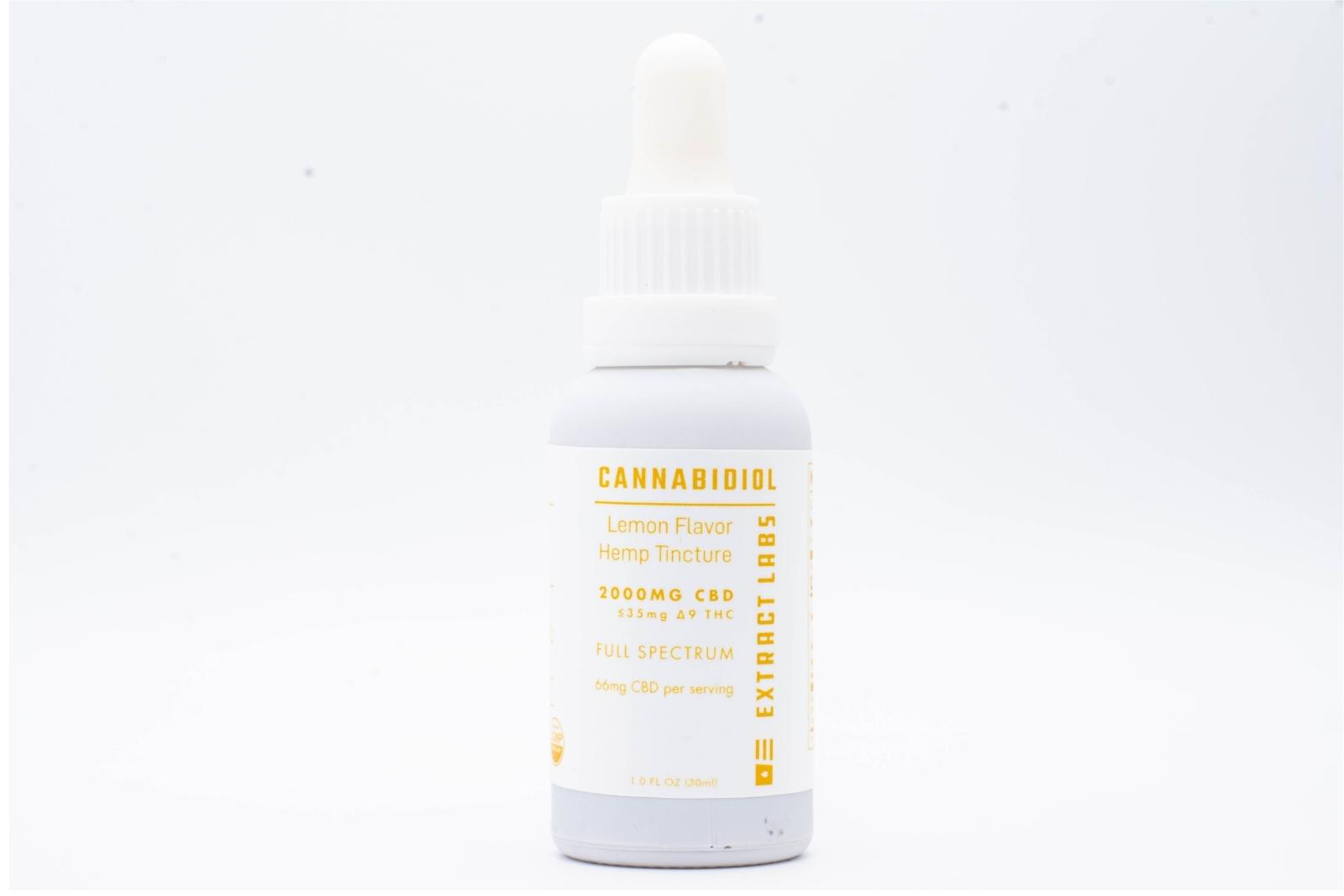 A tincture of Extract Labs Extra Strength Lemon Hemp Extract on a white background