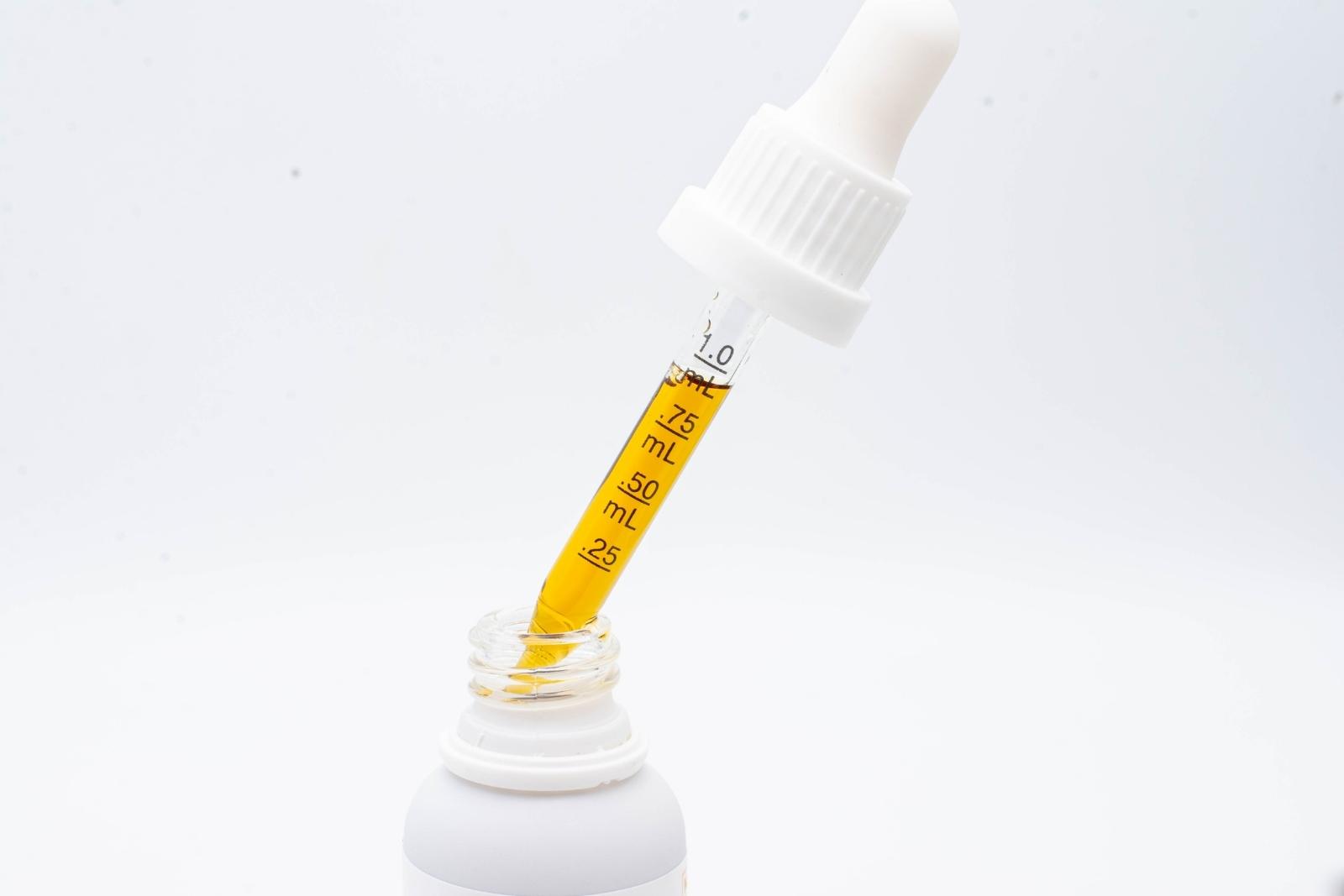 A dropper of Extract Labs Extra Strength Lemon Hemp Extract on a white background
