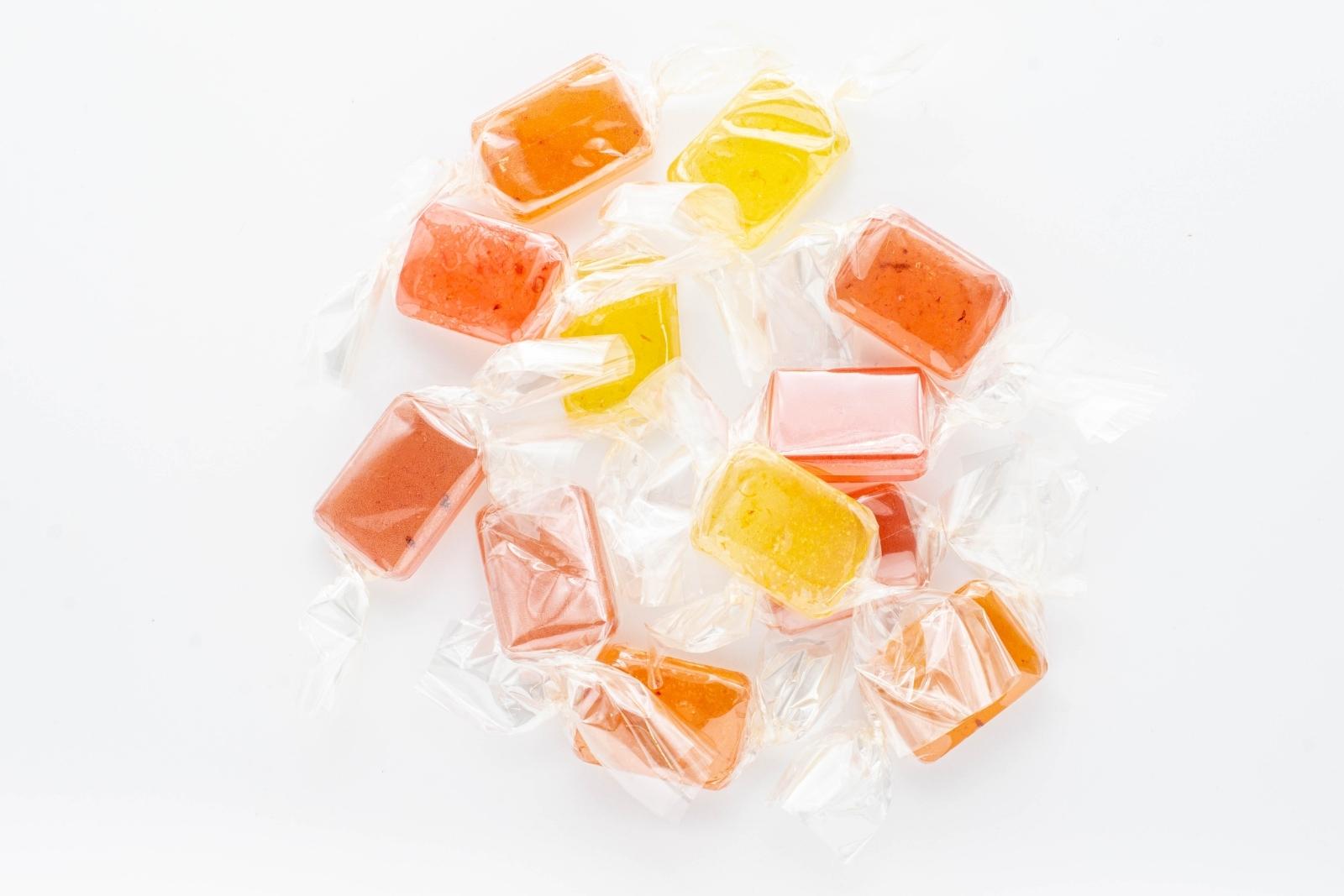 A group of the 12 hard candies, three of each flavor, that come in the Nice CBD Hard Candies Fruit Stand, on a white background