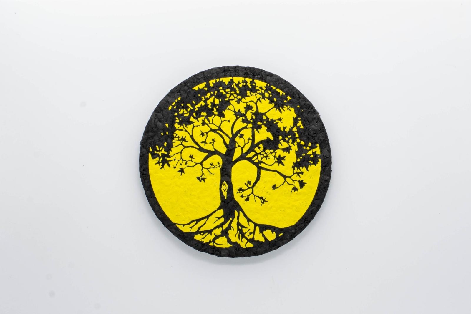 A yellow Tree of Life rubber dab mat from East Coasters, on a white background
