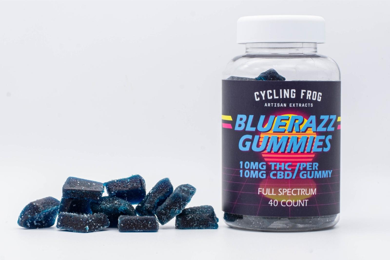 A pile of BlueRazz THC and CBD Gummies by Cycling Frog, next to a 40-count container, on a white background