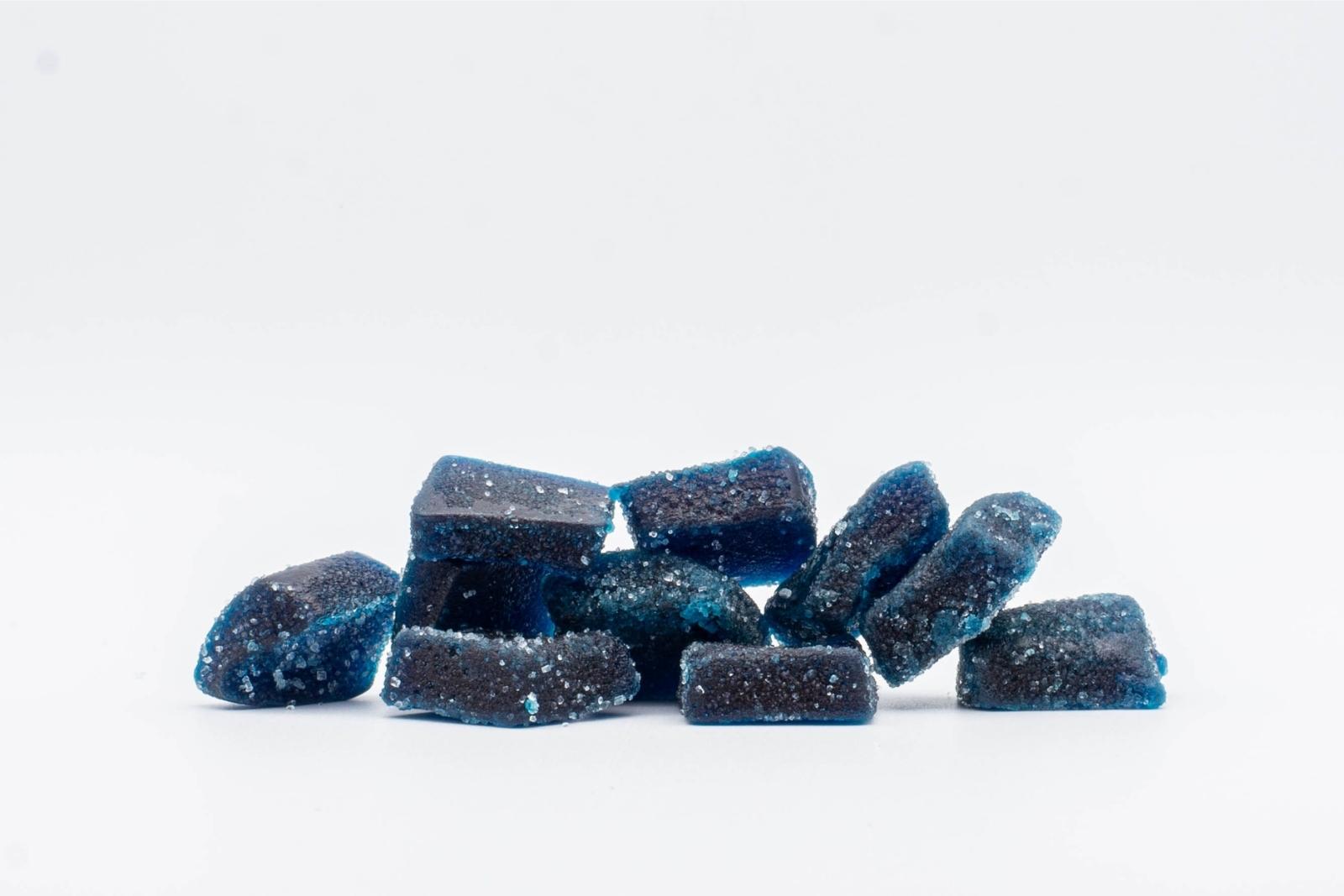A pile of BlueRazz THC and CBD Gummies by Cycling Frog,on a white background