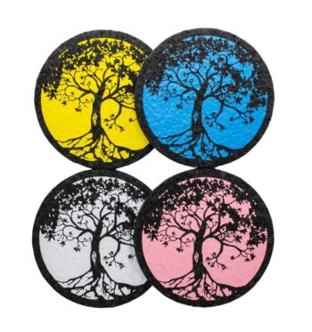 Four colors of Tree of Life rubber dab mat by East Coasters, on a clear background