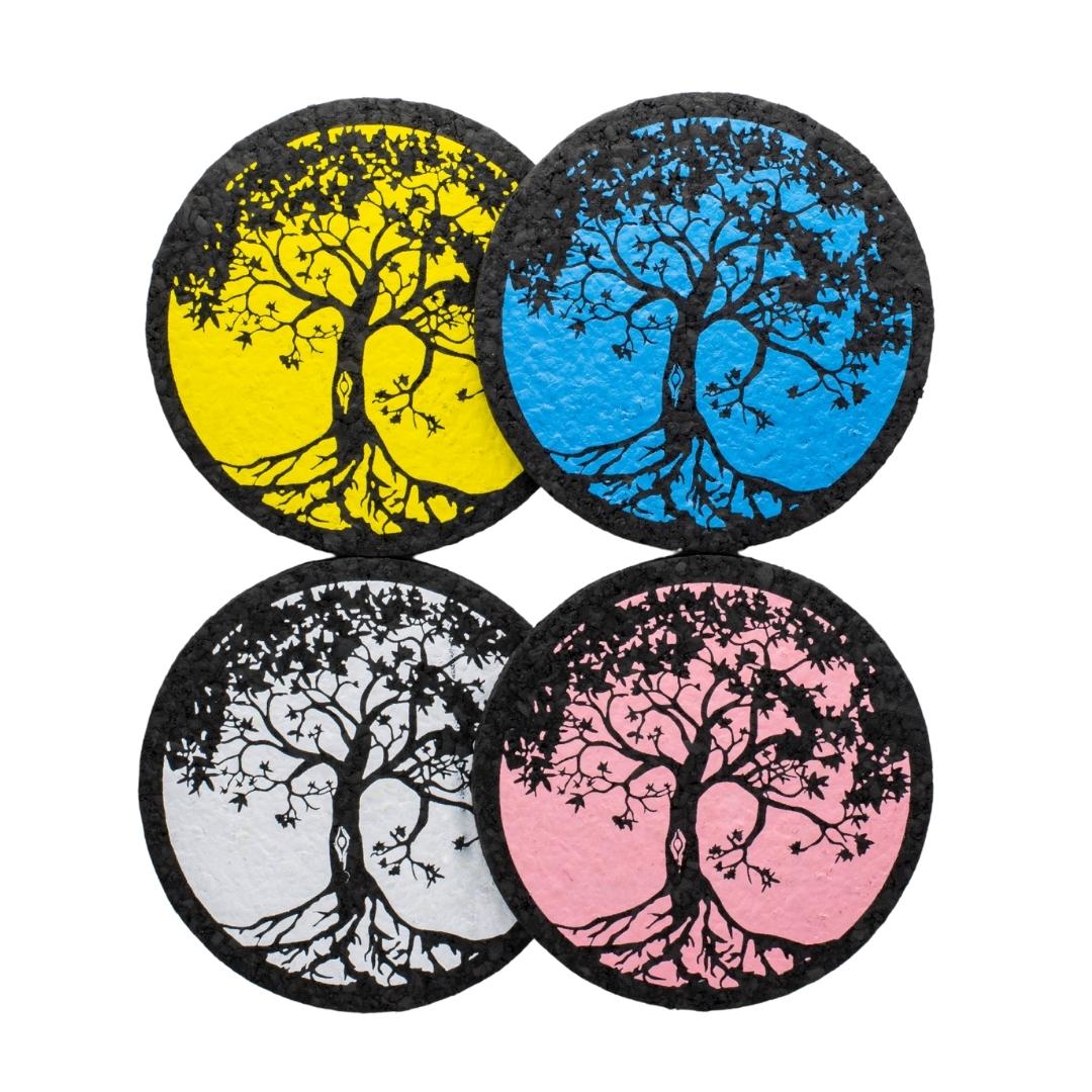 Four colors of Tree of Life rubber dab mat by East Coasters, on a clear background