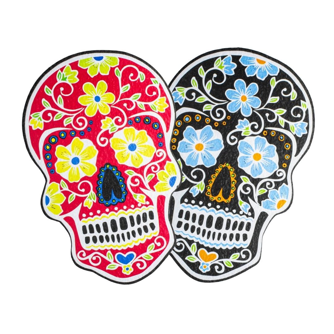 Two variations of the Die Cut Sugar Skull rubber dab mat from East Coasters, on a white background