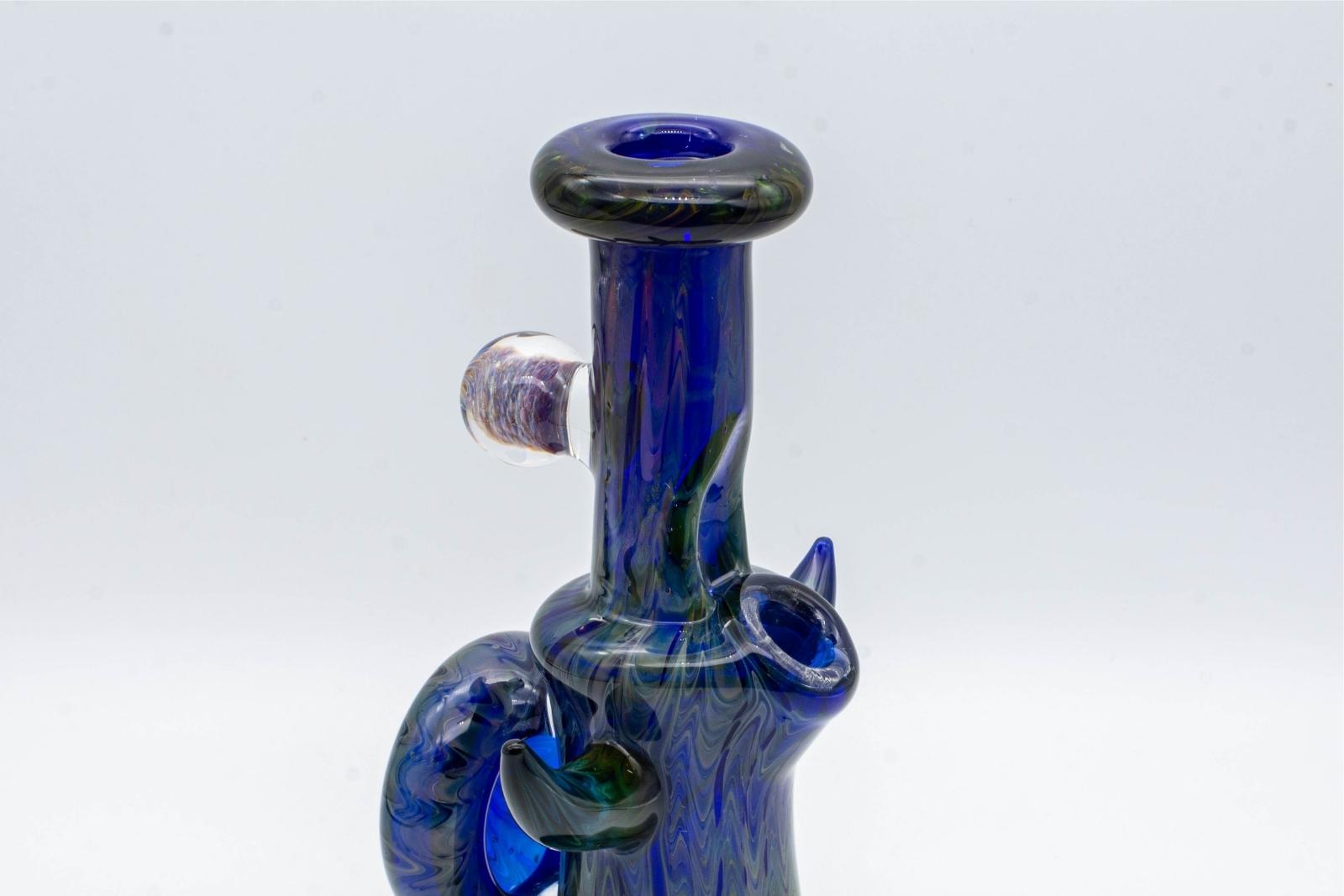 A cobalt and gold fumed, 6-inch jammer, made by GooMan Glass, on a white background