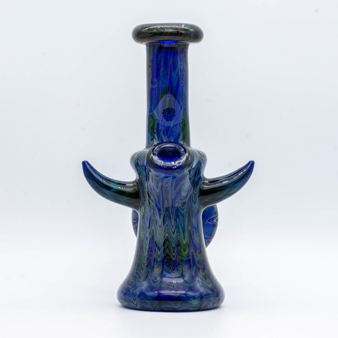 A cobalt and gold fumed, 6-inch jammer, made by GooMan Glass, on a white background