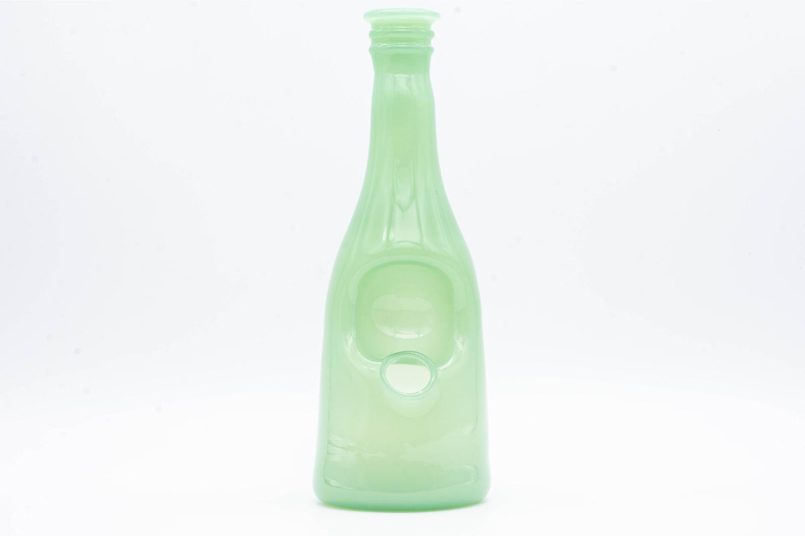 A seafoam green sake bottle rig by Costa Glass, on a white background