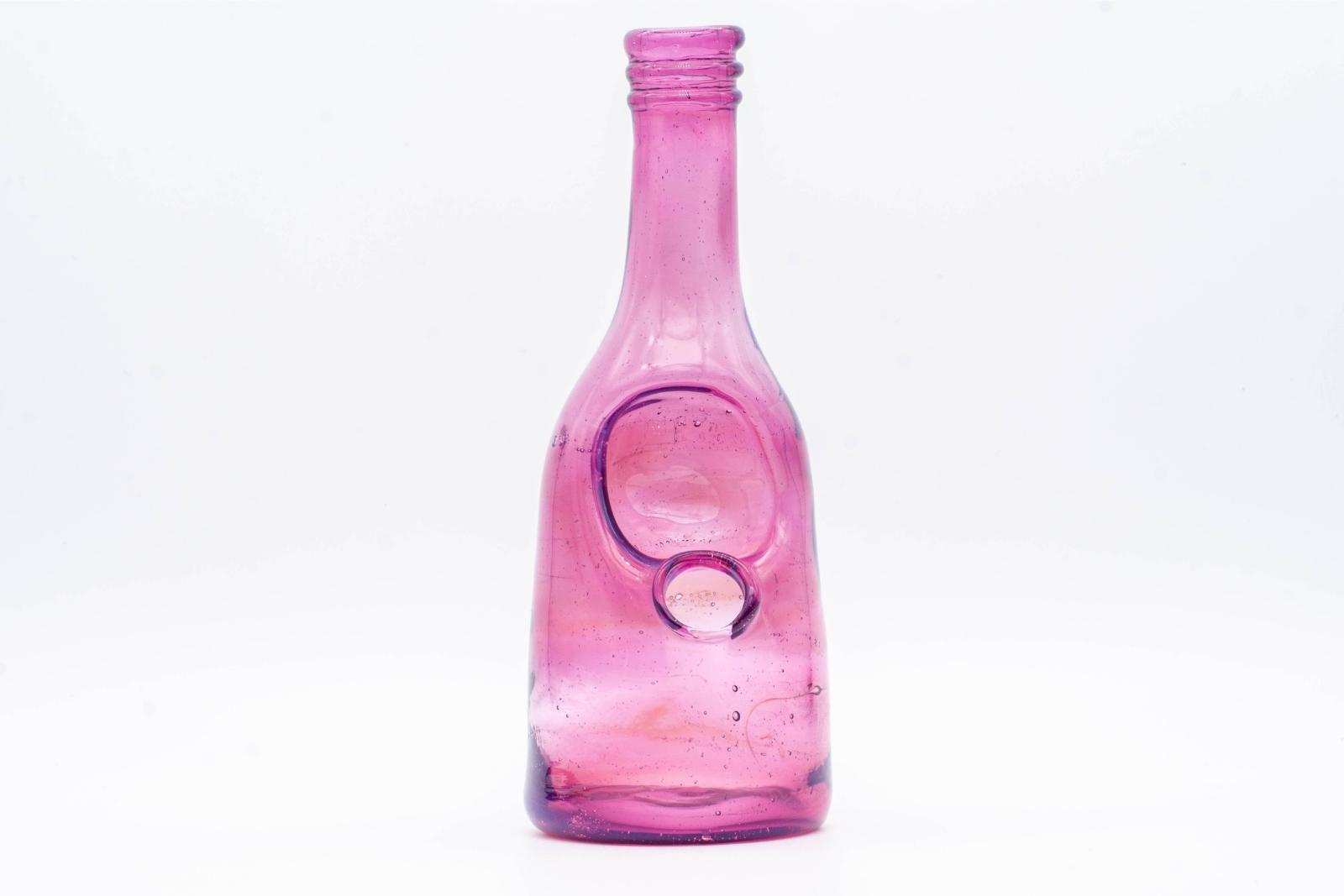 A purple sake bottle rig by Costa Glass, on a white background