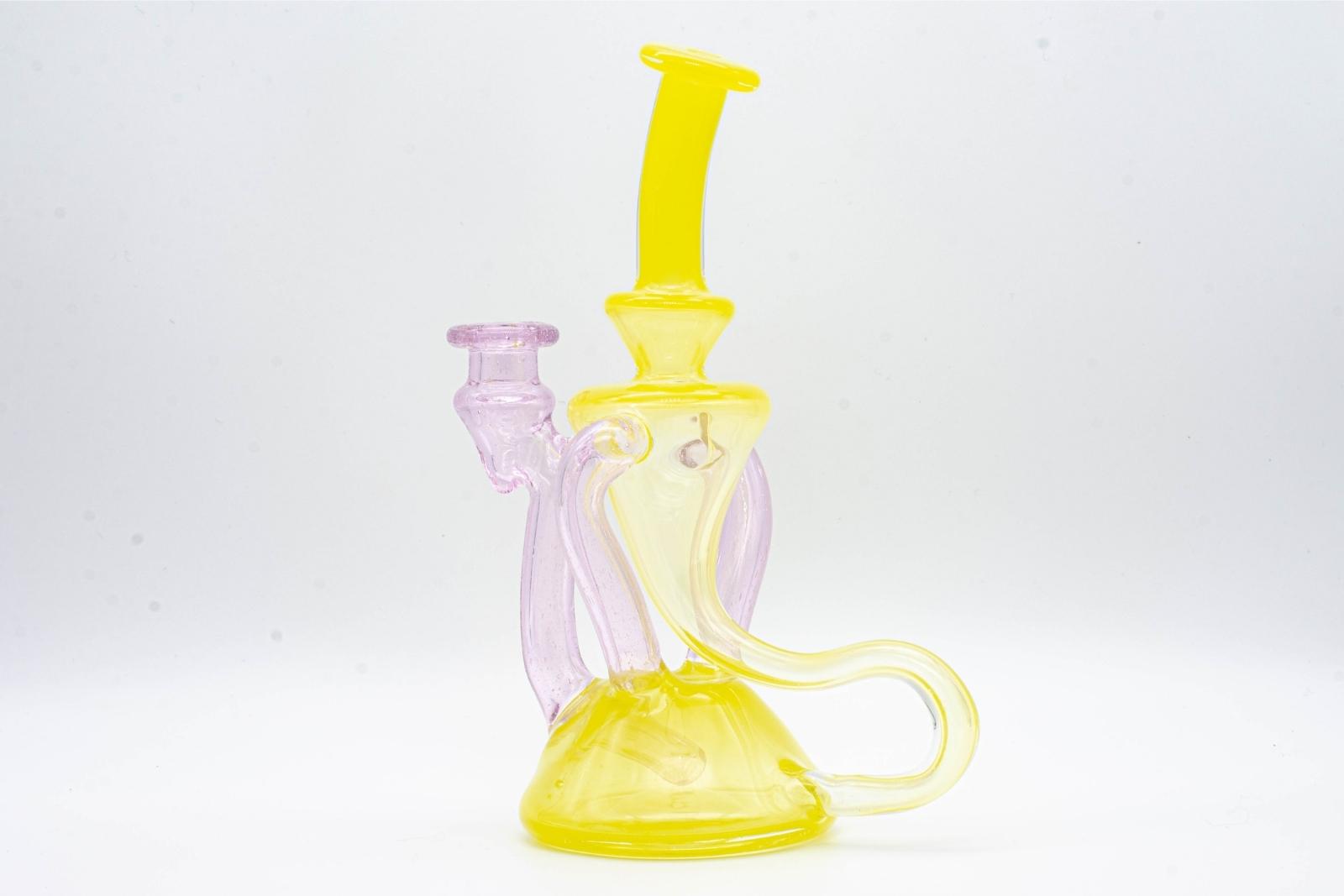 A yellow and pink dual recycler by Quasi Glass, on a white background