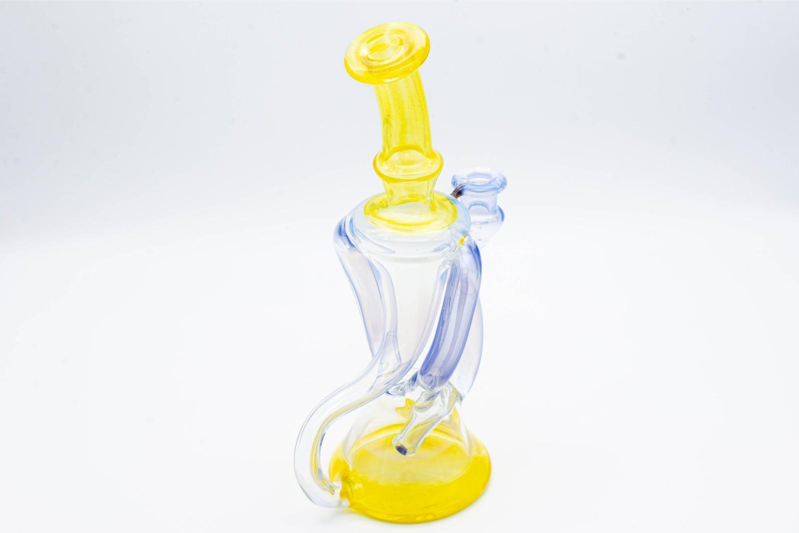 A blue and yellow dual recycler by Quasi Glass, on a white background