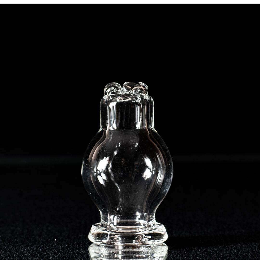 A clear spinner bubble cap, made by BorOregon, on a black background
