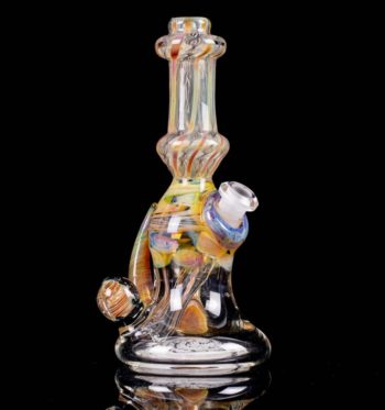 An amber honey, 6-inch glass rig, made by Bradfurd Glass, on a black background