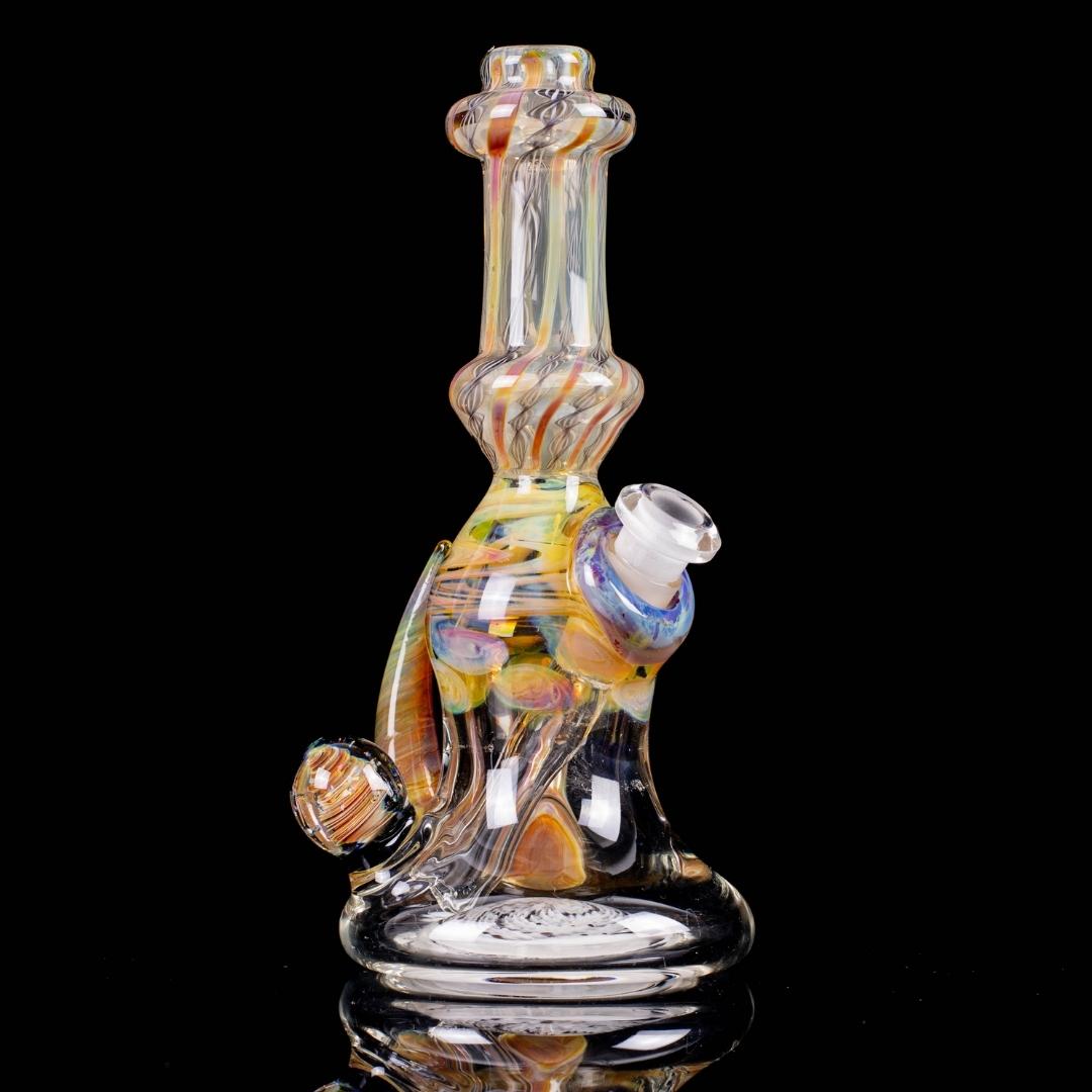 An amber honey, 6-inch glass rig, made by Bradfurd Glass, on a black background