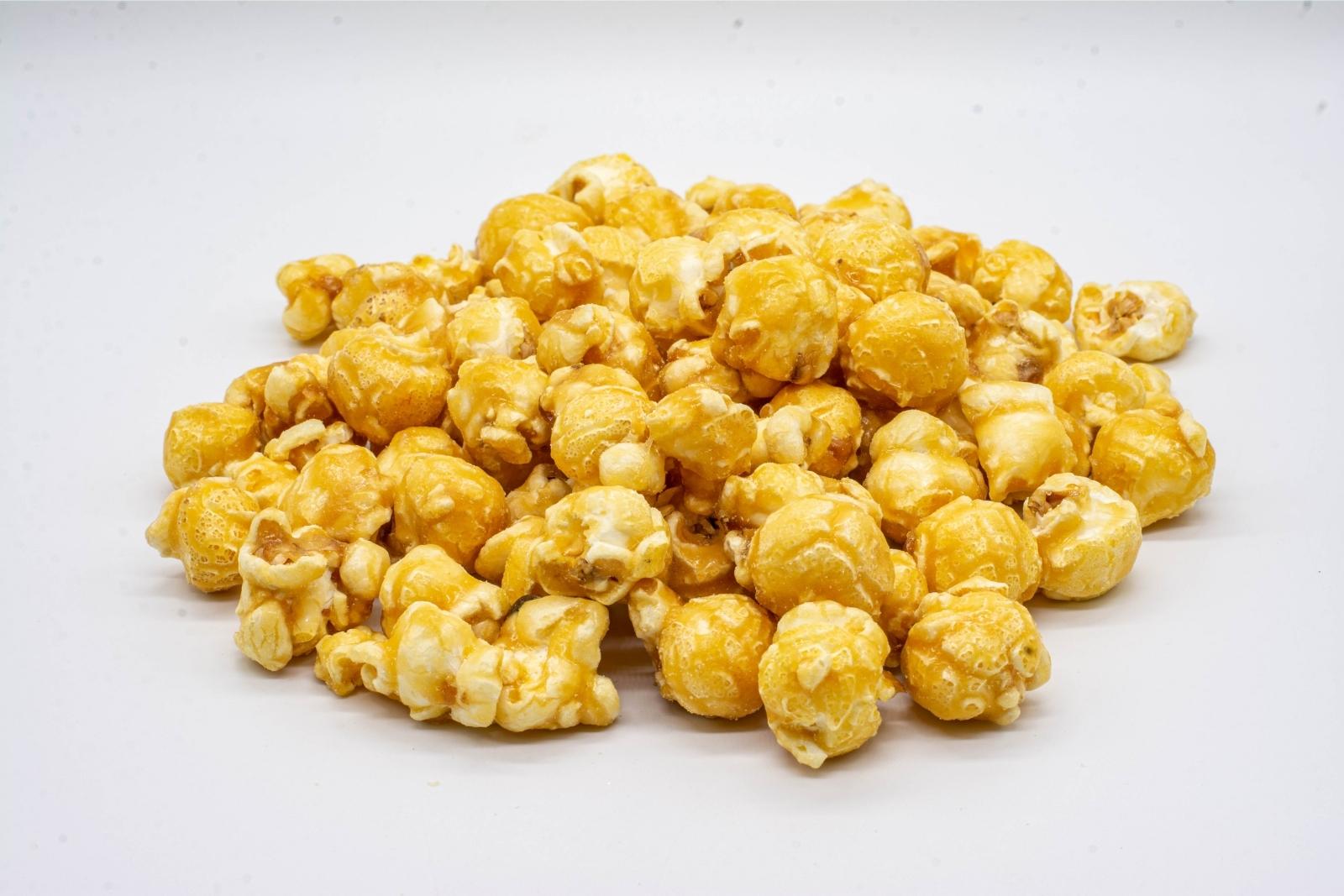A pile of loose 1:1 Caramel Popcorn, made by XITE, on a white background