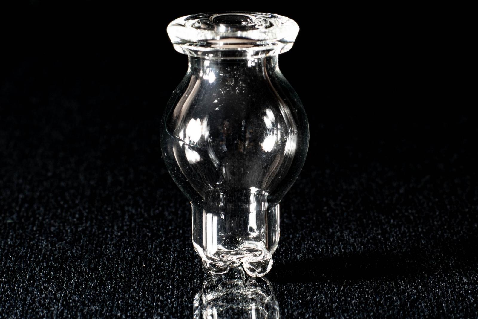 A clear spinner bubble cap, made by BorOregon, on a black background