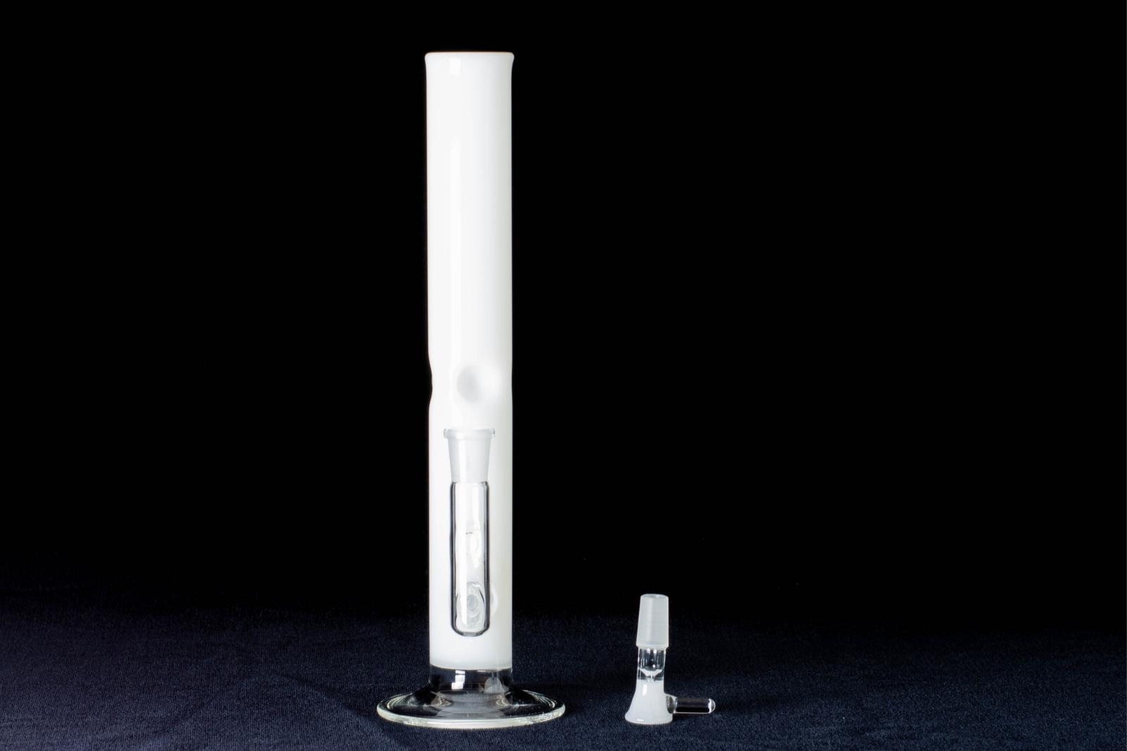 A white, 12-inch straight tube, made by Jack Glass Co., next to its slide, on a black background