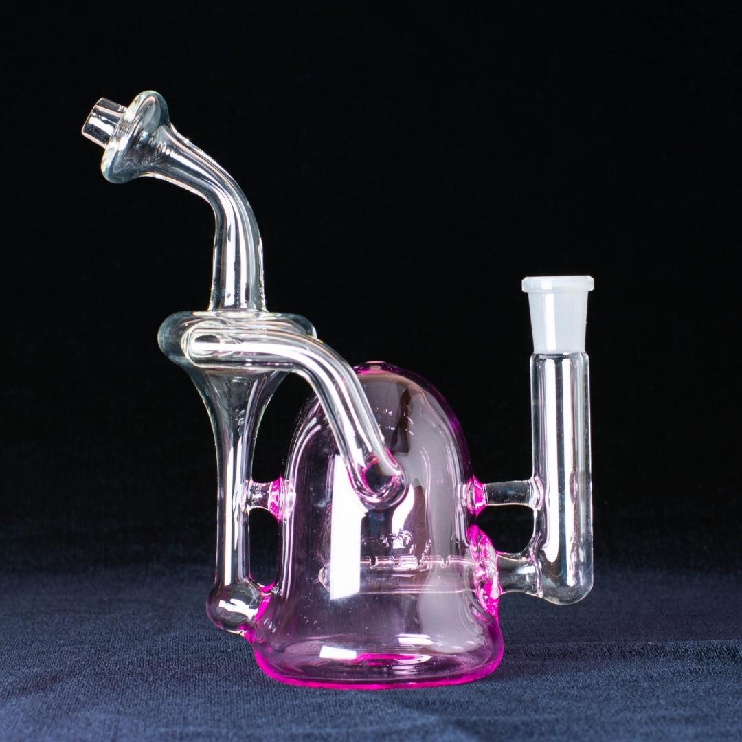 A pink 7-inch recycler made by Jack Glass Co., on a black background