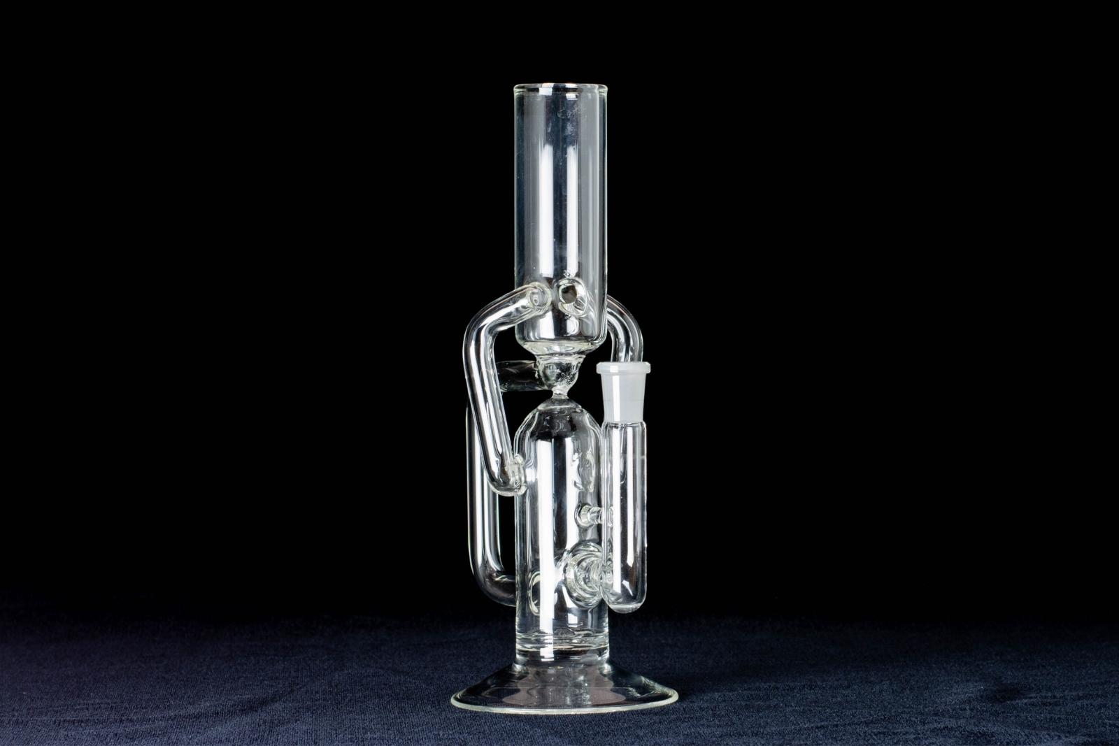 A clear, 10-inch tube cycler, made by Jack Glass Co., on a black background