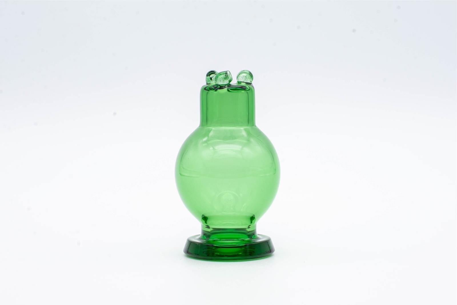 A clear green spinner bubble cap made by BorOregon, on a white background