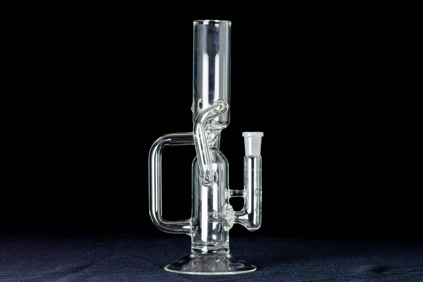 A clear, 12-inch tube cycler, made by Jack Glass Co., on a black background