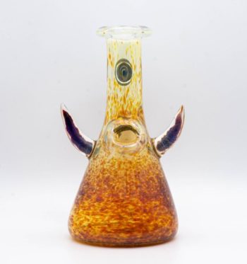A gold, 6-inch jammer, made by GooMan Glass, on a white background