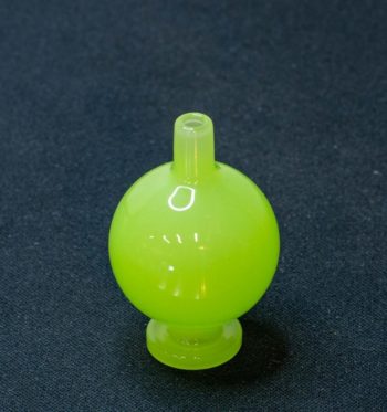 A light green bubble cap made by BorOregon, on a black background