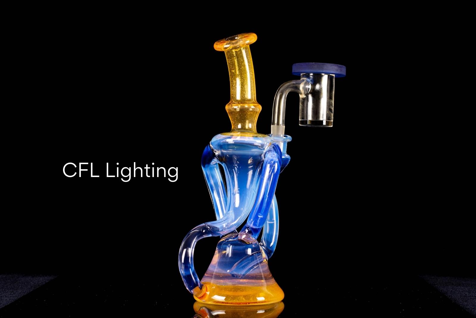A blue and yellow dual recycler by Quasi Glass, on a black background