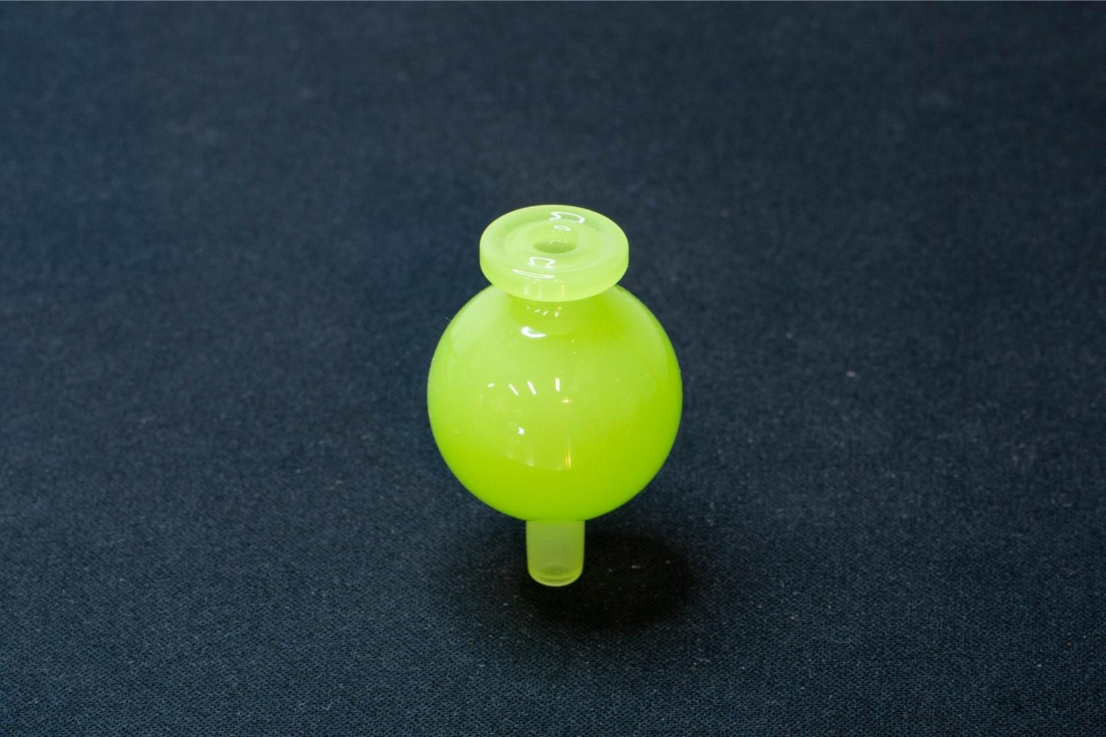 A light green bubble cap made by BorOregon, on a black background