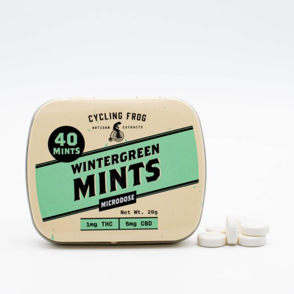 One container of Wintergreen THC Mints by Cycling Frog, next to a small pile of the mints, on a white background