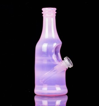 A pink sake bottle rig by Costa Glass, on a black background