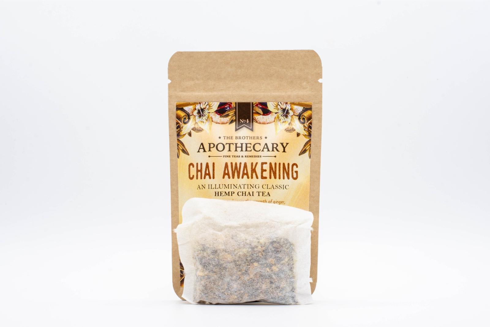 A tea bag in front small packet of The Brothers Apothecary's Chai Awakening CBD Tea on a white background