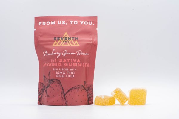 A bag of 3:1 Sativa Hybrid Gummies by Seventh Hill CBD, next to a pile of the gummies, on a white background