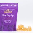 A bag of 3:1 Indica Gummies by Seventh Hill CBD, next to a pile of the gummies, on a white background