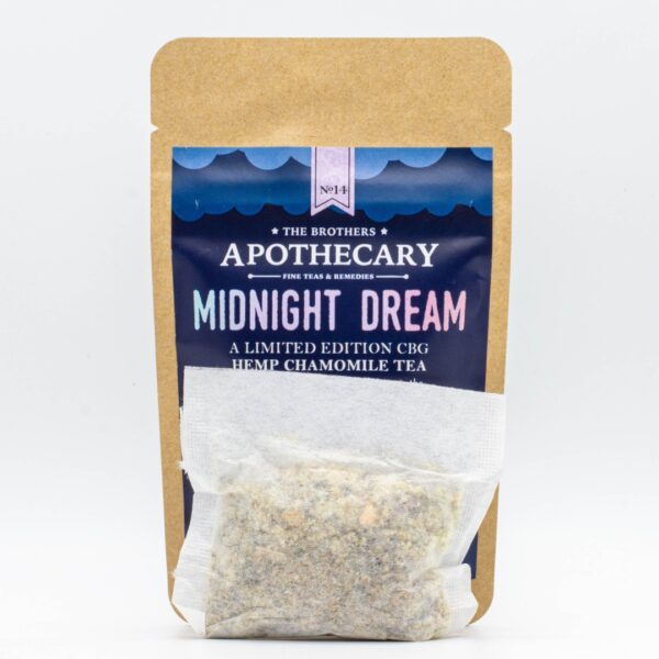 A tea bag in front small packet of The Brothers Apothecary's Midnight Dream Tea on a white background