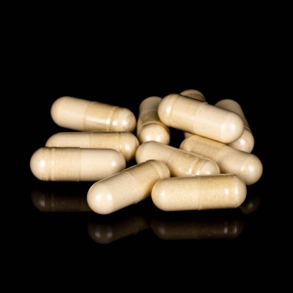 A pile of Plant Science Laboratories CBG Capsules, on a black background