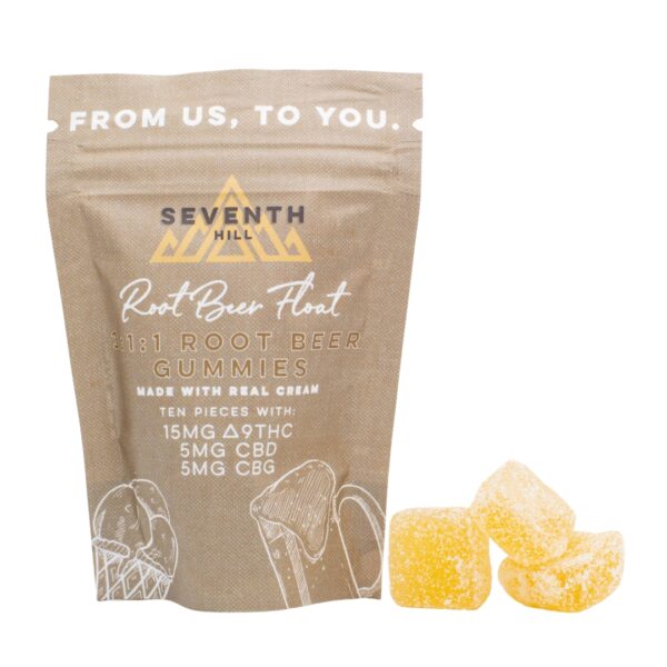 A package of Seventh Hill CBD's 3:1 Root Beer Float Gummies, next to a pile of the gummies, on a clear background