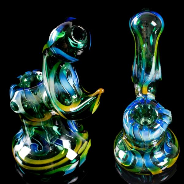 A Paul Taylor Glass Fumed Over Color Bubbler, showing two different angles, on a black background
