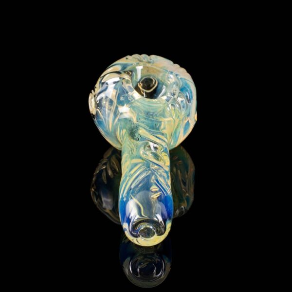 A Paul Taylor Glass Carved Basic Fume Spoon, on a black background.