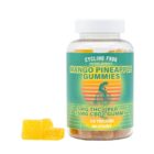 A jar of Cycling Frog 5:1 Mango Pineapple Gummies, next to a small pile of the gummies, on a clear background.