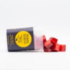 A container of Bison Botanics 1:1 Sleep Gummies, tipped over to reveal the gummies, on a white background