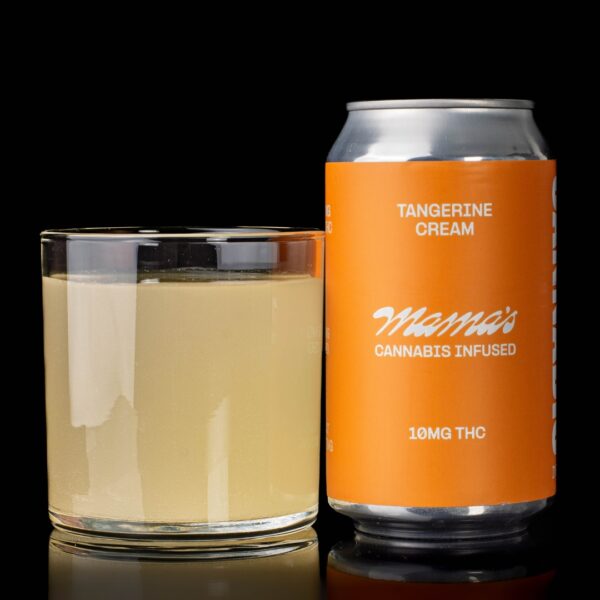 A single can of tangerine cream flavored Mama's Infused Beverages, next to a clear glass container containing the drink, on a black background