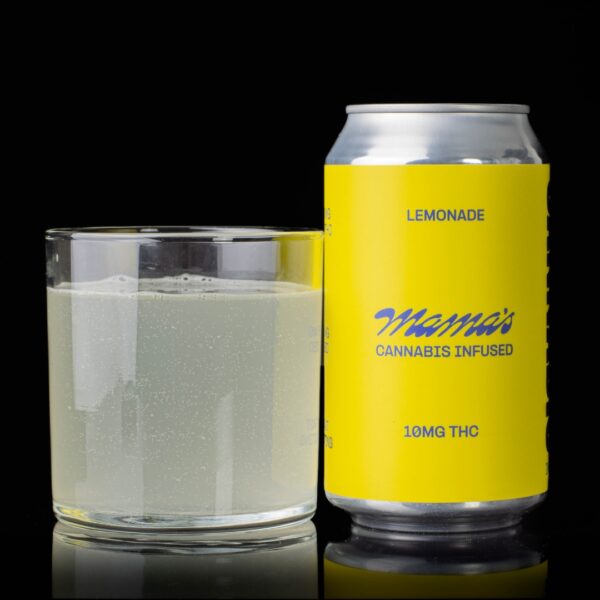 A single can of lemonade flavored Mama's Infused Beverages, next to a clear glass container containing the drink, on a black background