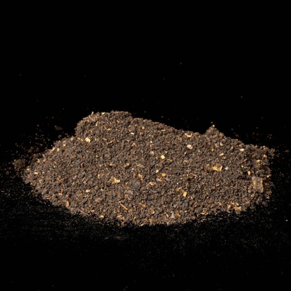 A small pile of worm castings from BFLO Worm Works, on a black background