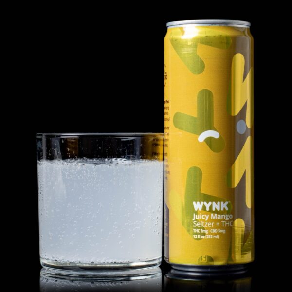 A single can of Juicy Mango flavored WYNK Infused Seltzers, next to a clear glass container containing the drink, on a black background
