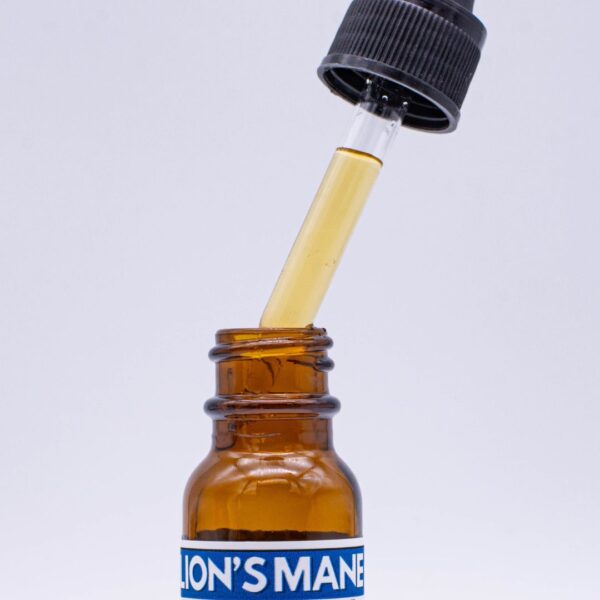 A close up view of Hana Mushroom's Lion's Mane tincture dropper filled with Lion's Mane tincture to show the color of the liquid.